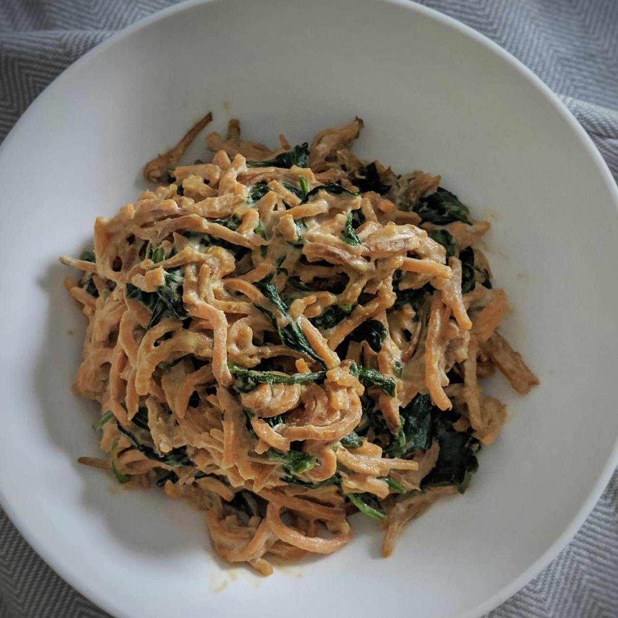 Creamy sweet potato noodles in a bowl.