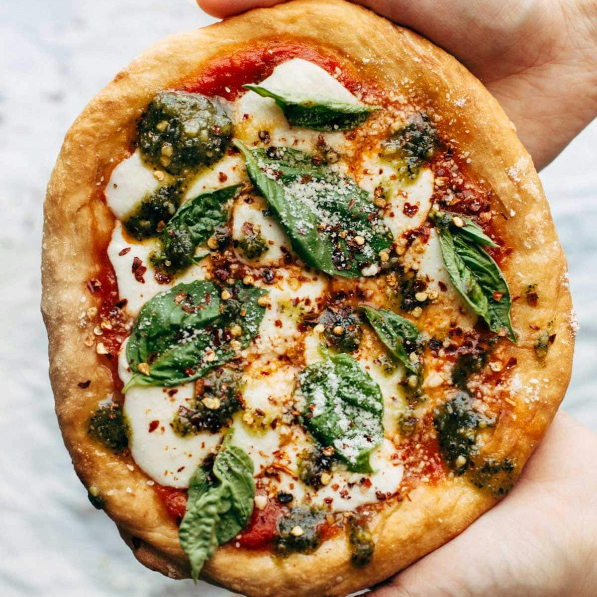 Person holding fried pizza