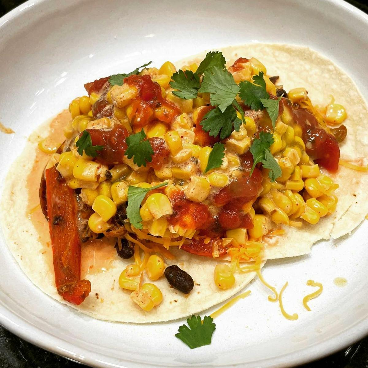 Chicken tacos on a plate with corn