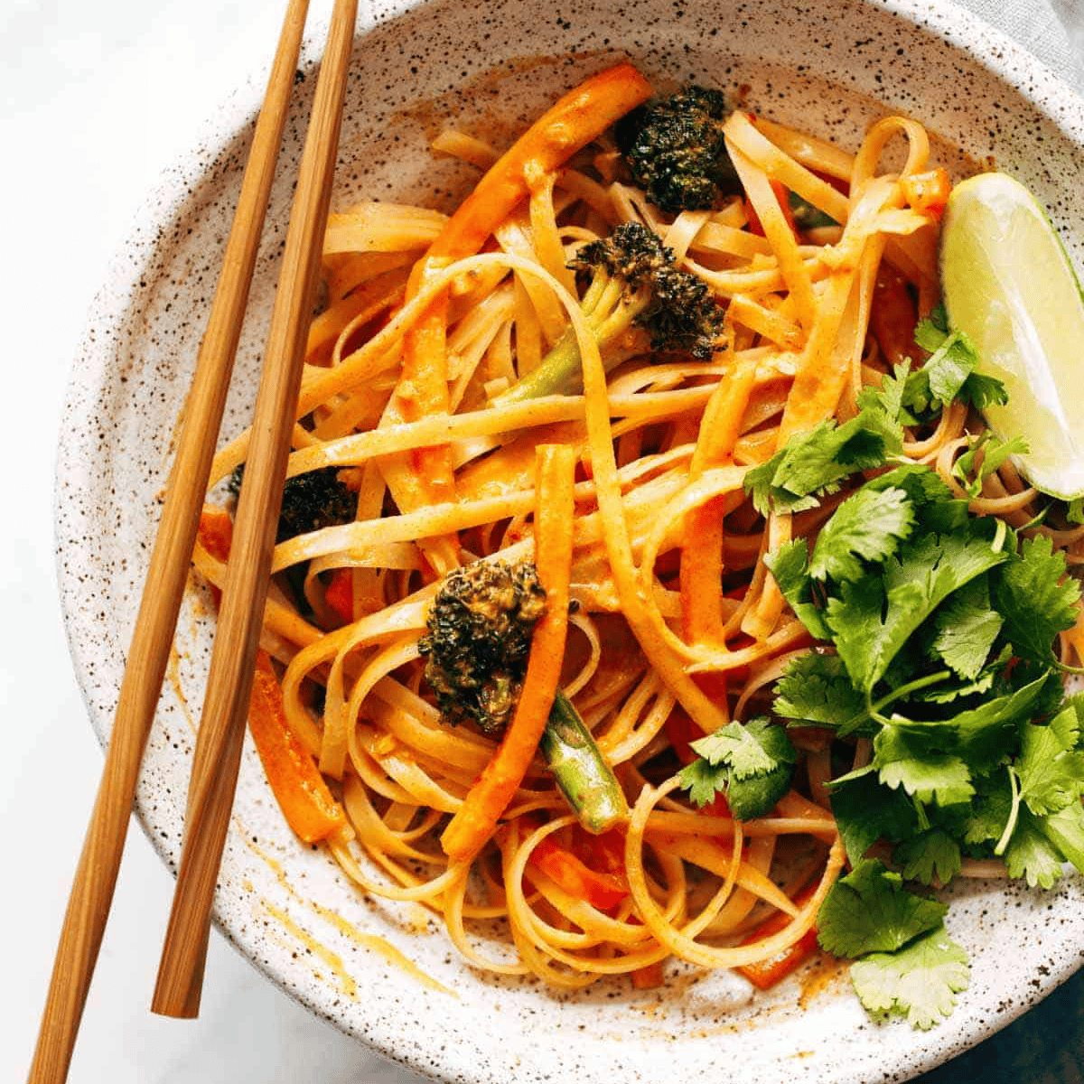 Red Curry Noodles in a bowl with choptsticks