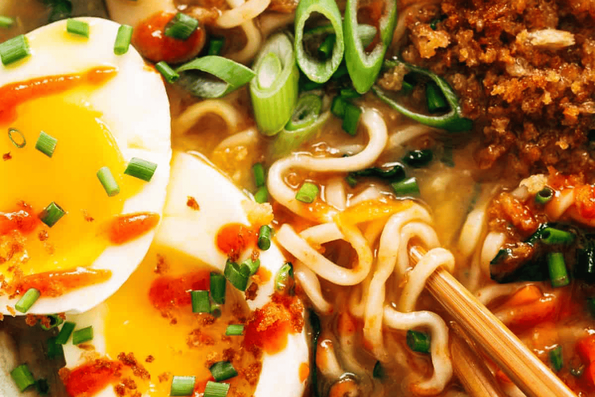 Close-up of Quick Homemade Ramen with soft boiled egg in a bowl with chopsticks