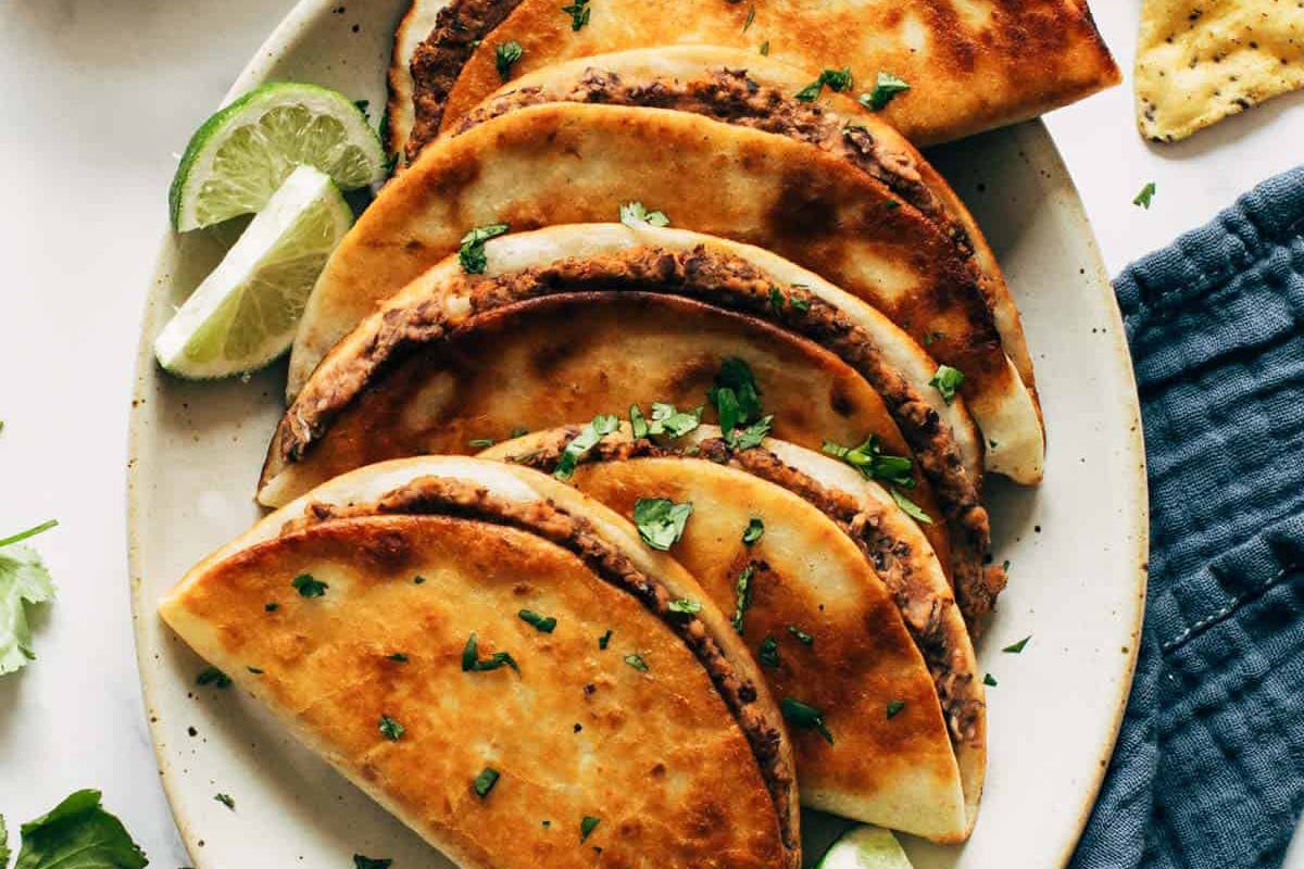 Crispy Black Bean Tacos on a plate with limes