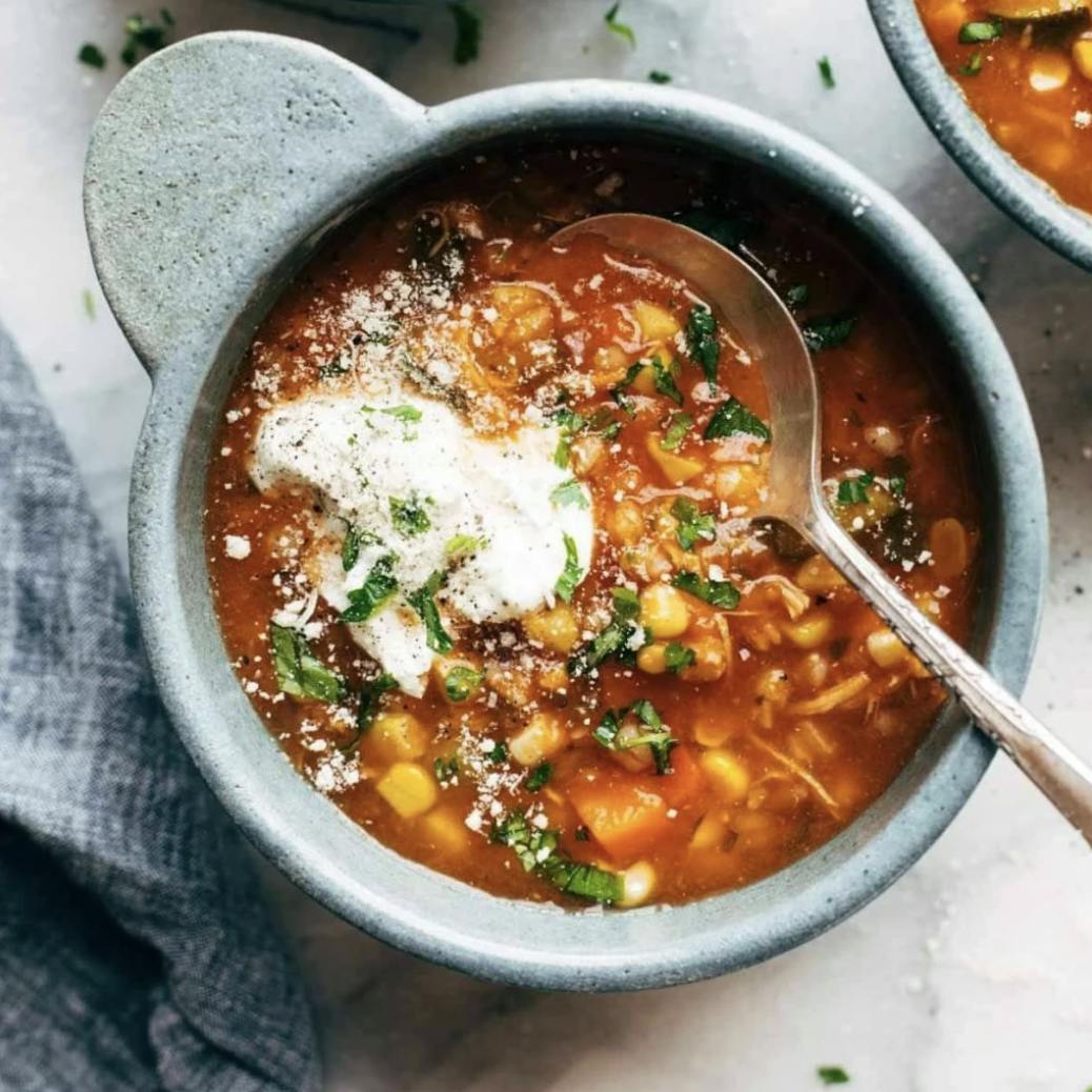 Summer soup in a bowl with yogurt on top.