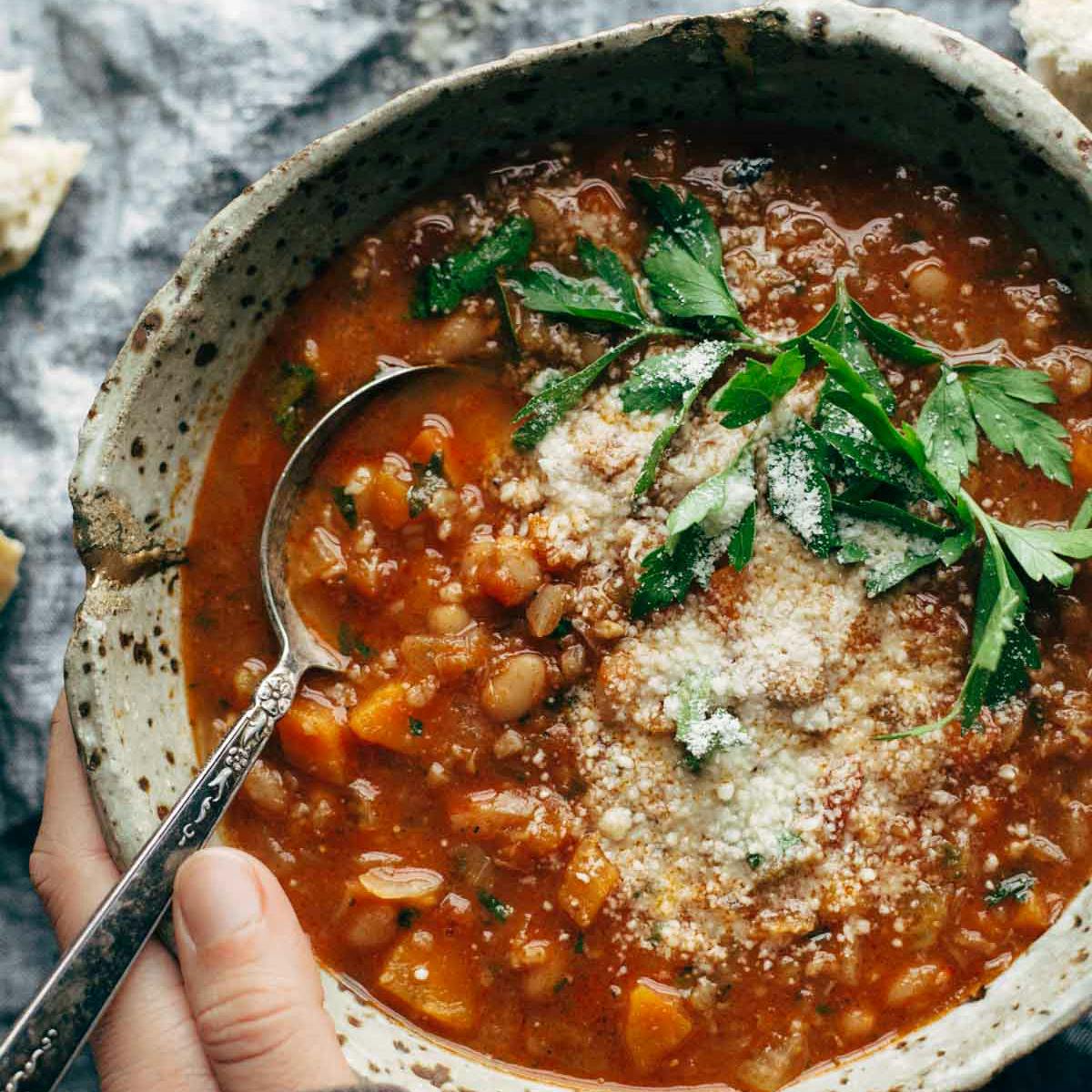 Instant Pot Minestrone in a bowl with a spoon topped with parsley