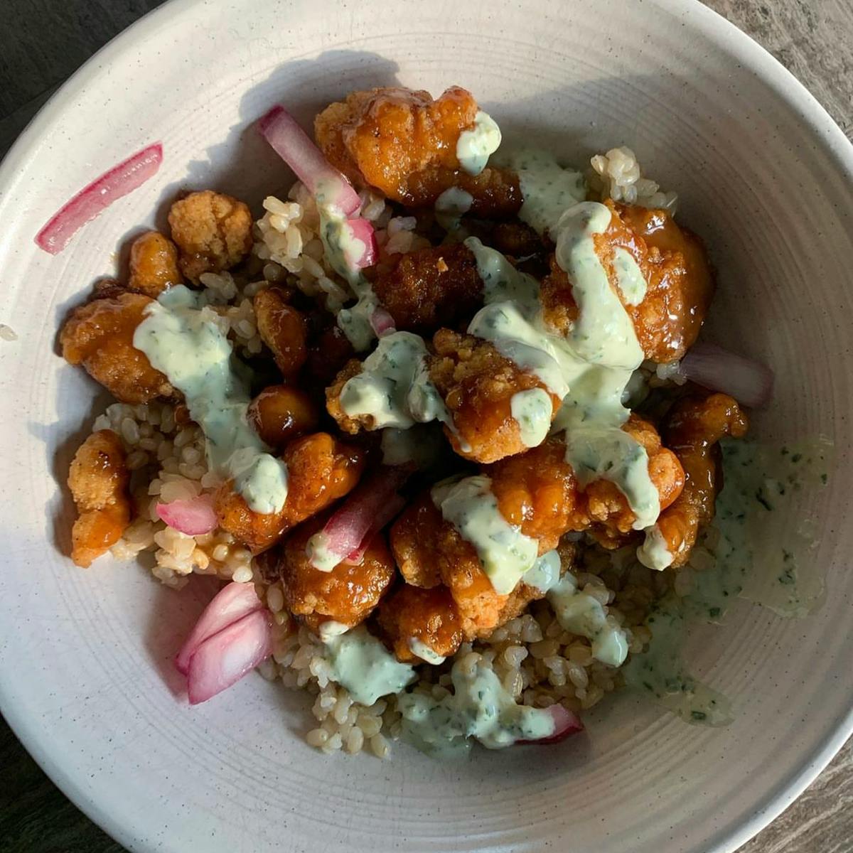 Chicken tikka bowls with pickled onions, rice, and mint sauce