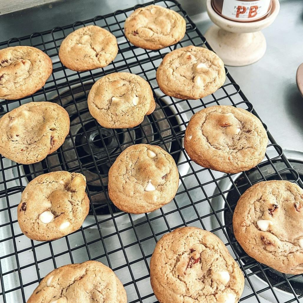 Strawberry white chocolate cookies on a cooling rack.