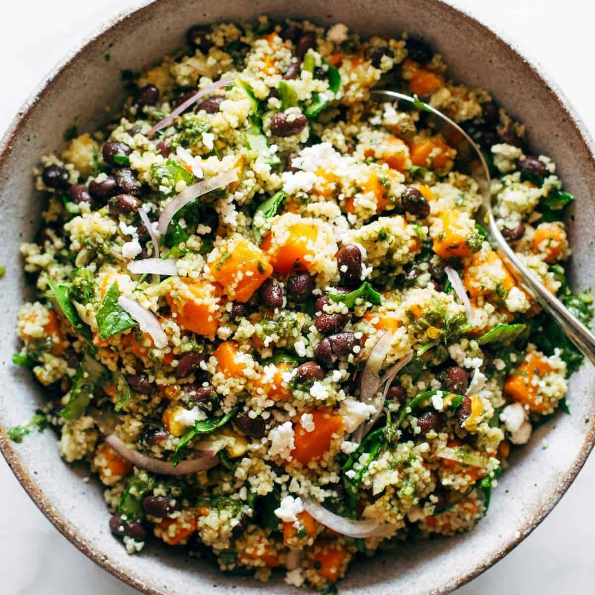 Couscous salad in a bowl with a spoon