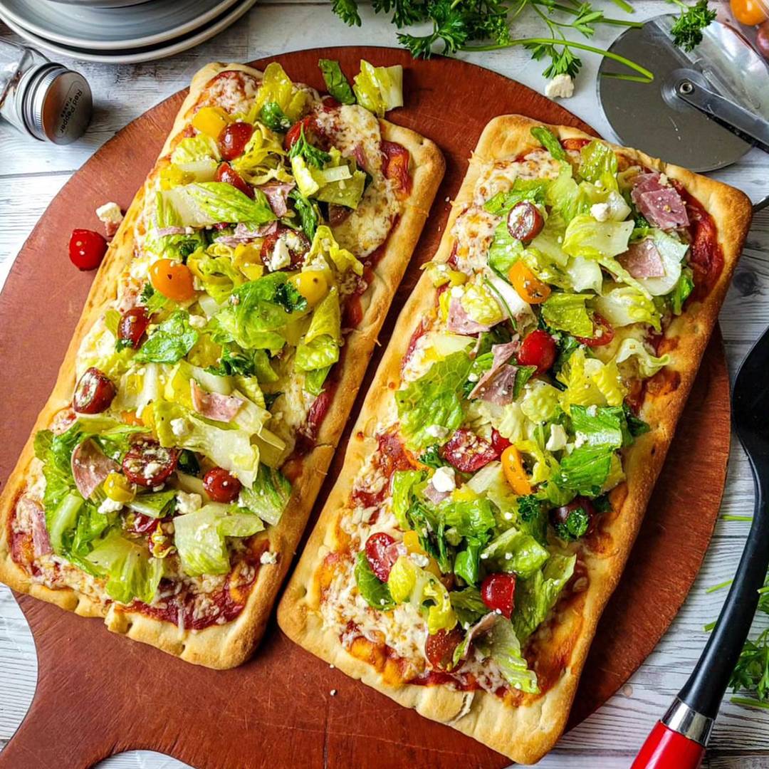 Chopped salad pizzas on a cutting board