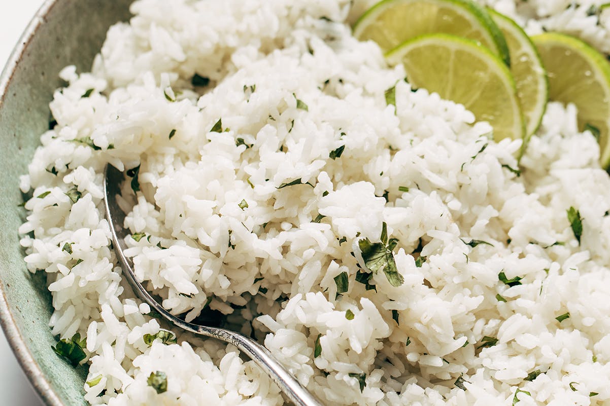 White rice in a bowl with a spoon. 