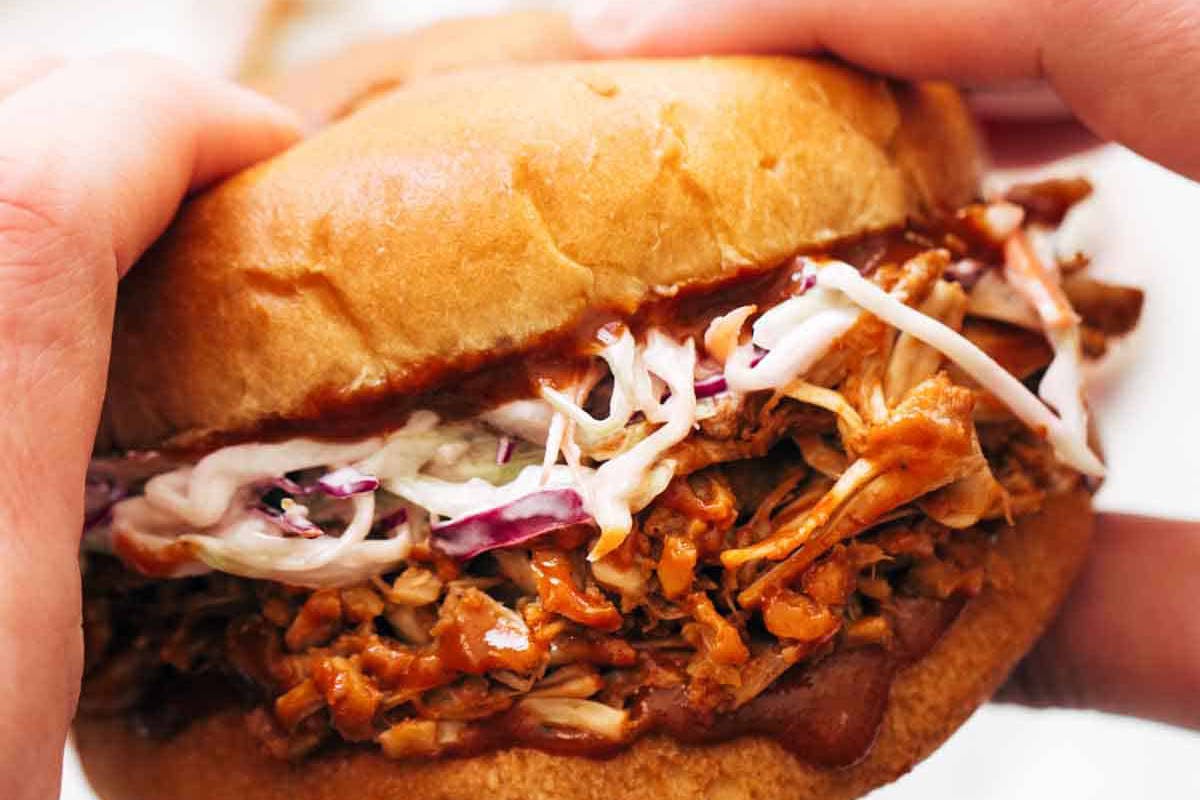 Person holding BBQ Jackfruit Sandwich