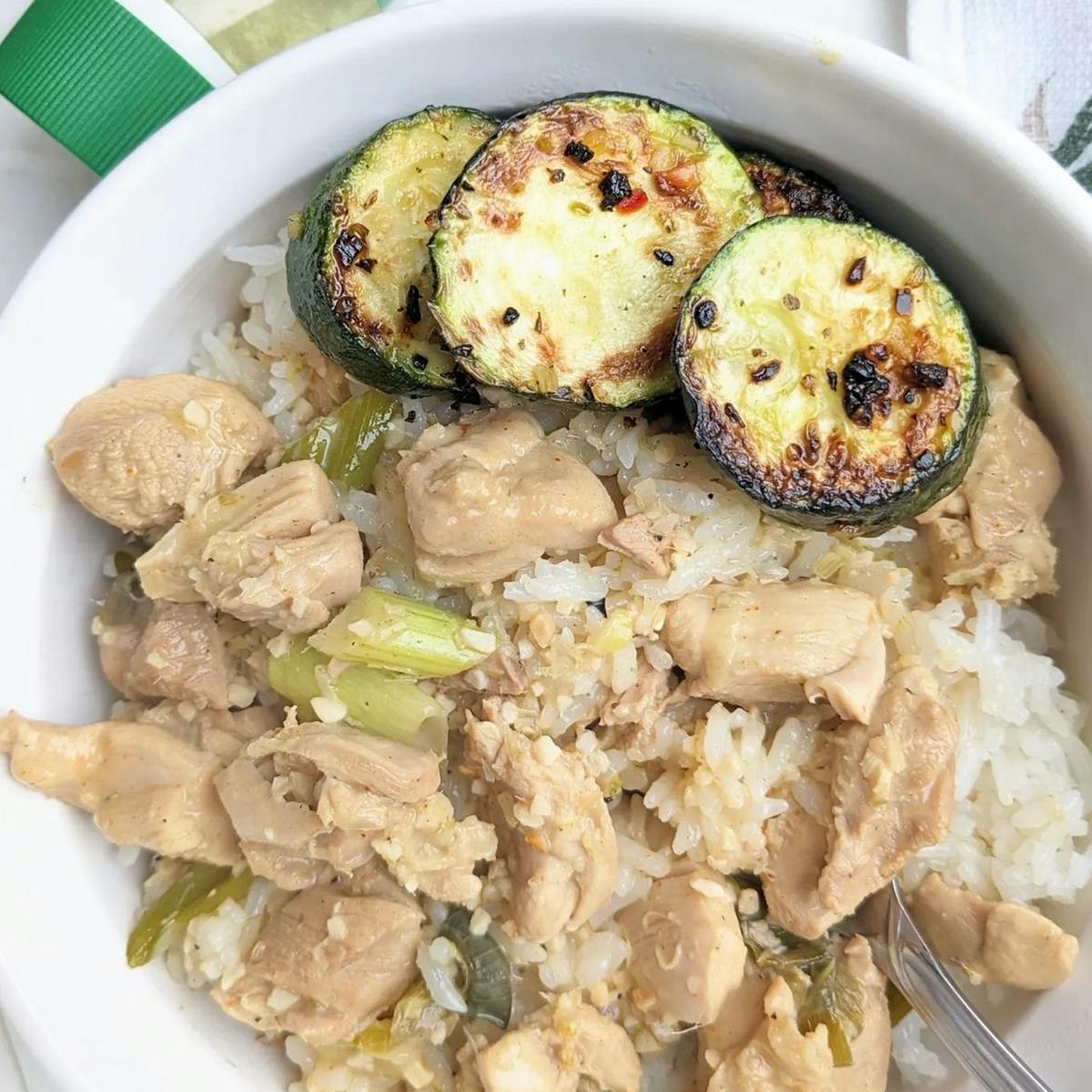 Lemongrass chicken in a bowl with rice and zucchini