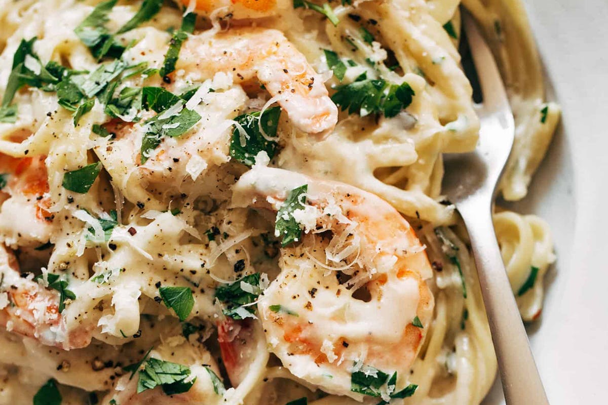 Garlic butter white wine linguine in a bowl with a fork