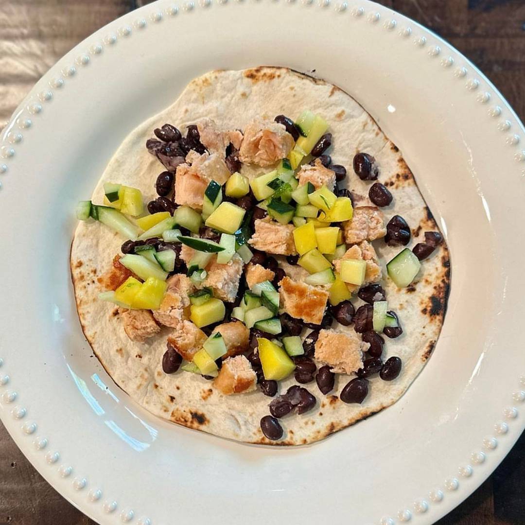 Salmon tacos on a plate with mango corn salsa