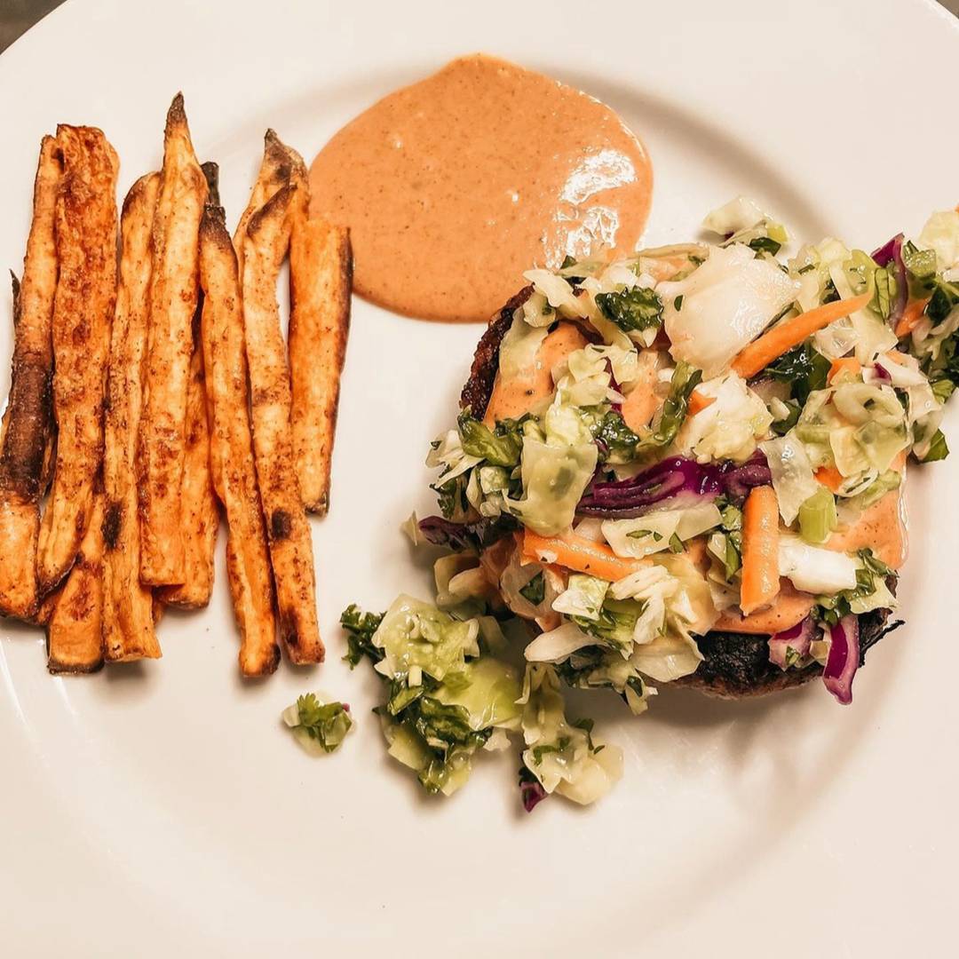 Chicken burger with slaw, yum yum sauce, and fries