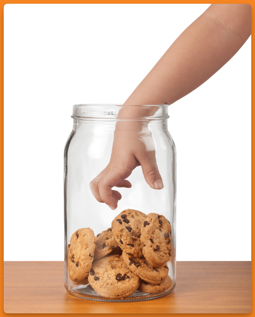 photo of a child with his or her hand reaching in a cookie jar