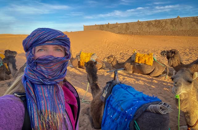 Beth Whitman traveling with camels in the Sahara, Morocco