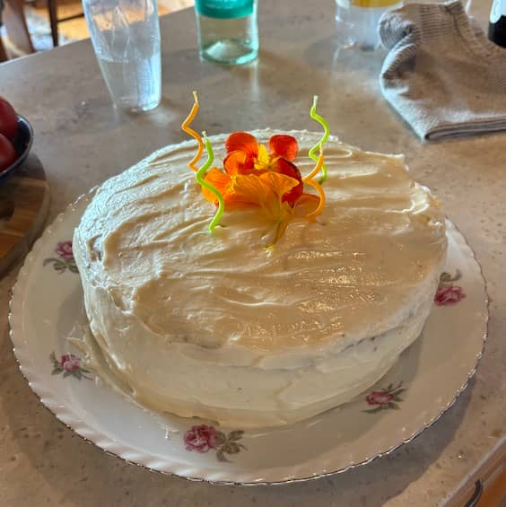 Photo of Andrea's Carrot Cake with cream cheese frosting and colorful editable Nasturtium | Photo: P. Burke