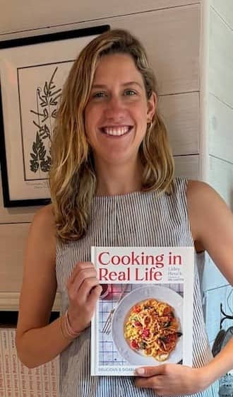 Photo of Lidey Hueck with her new book, Cooking in Real Life | Photo: P. Burke