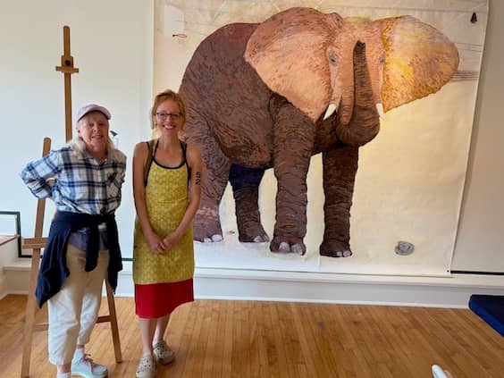 Publisher Pamela Burke with visual artist Lucky Platt in front of her large, breathtaking elephant collage at the Farnsworth Museum’s 365 Are Gallery | Photo: P. Burke