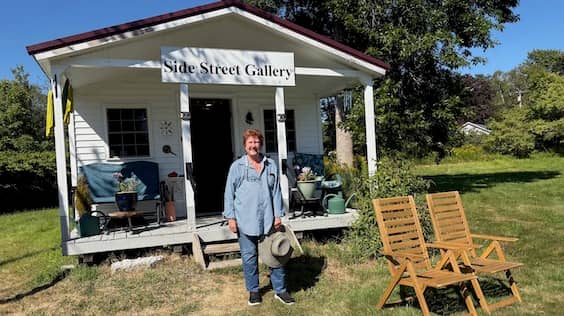 Artist Beth Berman standing in front of her small Side Street Gallery workshop in Searsport, Maine. | Photo: P. Burke