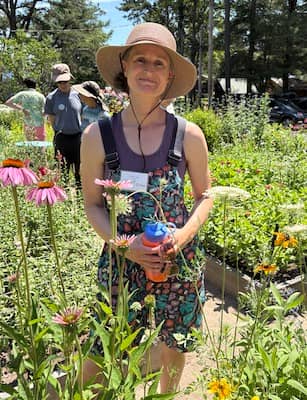 Linda Long, The Maine Garden Gnome, in front of her garden in bloom in Brunswick, Maine | Photo: P Burke