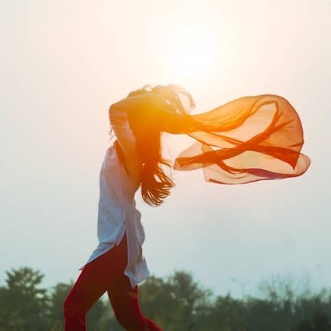 woman spreading hair at during sunset