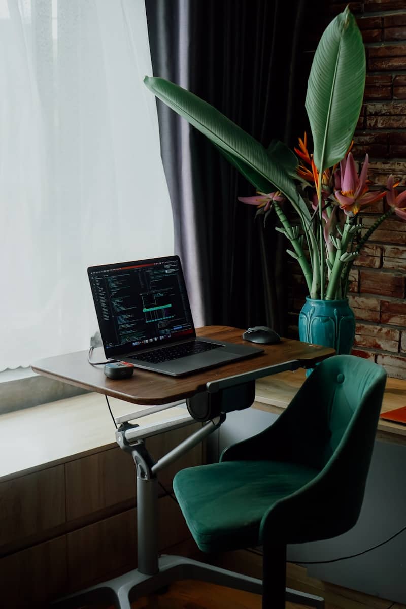 Laptop and flowers sit in a stylish home office.