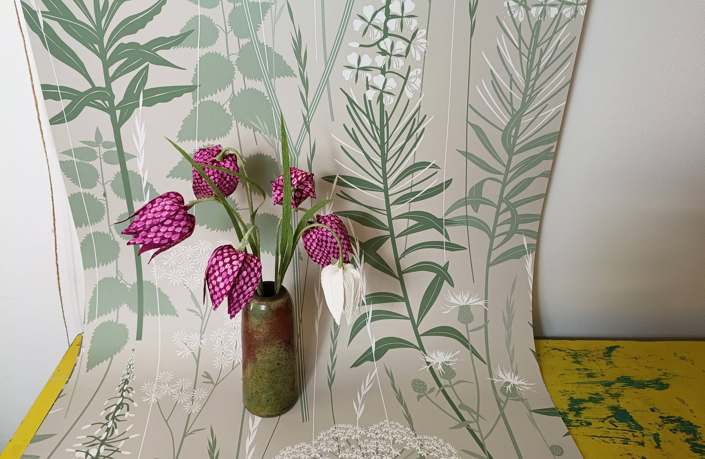 Paper fritillary photographed against Hannah Nunn's Wild Edge wallpaper