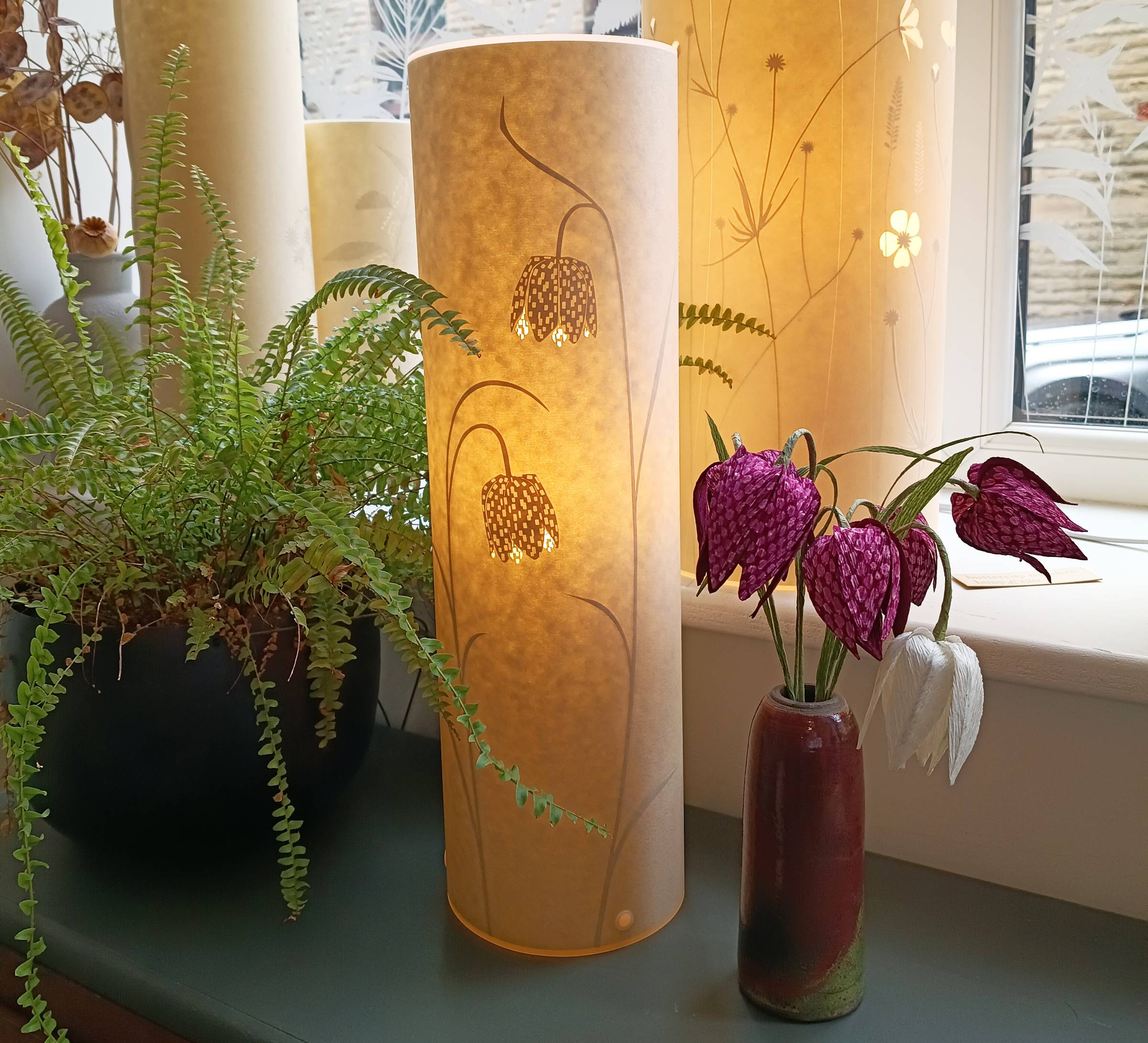 Paper fritillaries pictured next to a fritillary lamp.