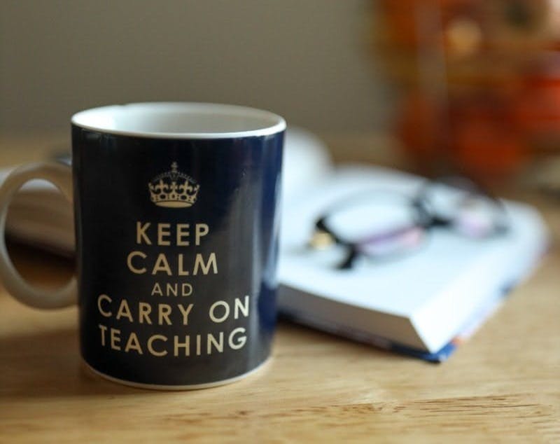 blue and white ceramic mug on brown wooden table