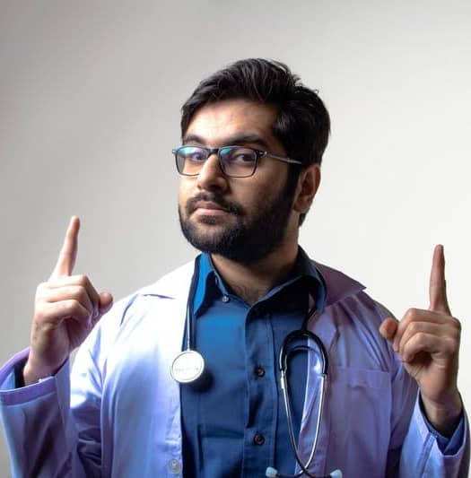 man in blue scrub shirt wearing black framed eyeglasses
