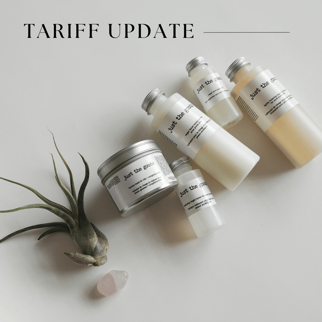 a top down view of 5 just the goods products in different formats (small and large bottles, and a jar) laid on a neutral surface on a diagonal moving from bottom left to upper right. At the bottom left of the arrangement of products is a small air plant and a rose quartz crystal. The overall image is soft and relaxing. The upper top left of the image reads "tariff update"