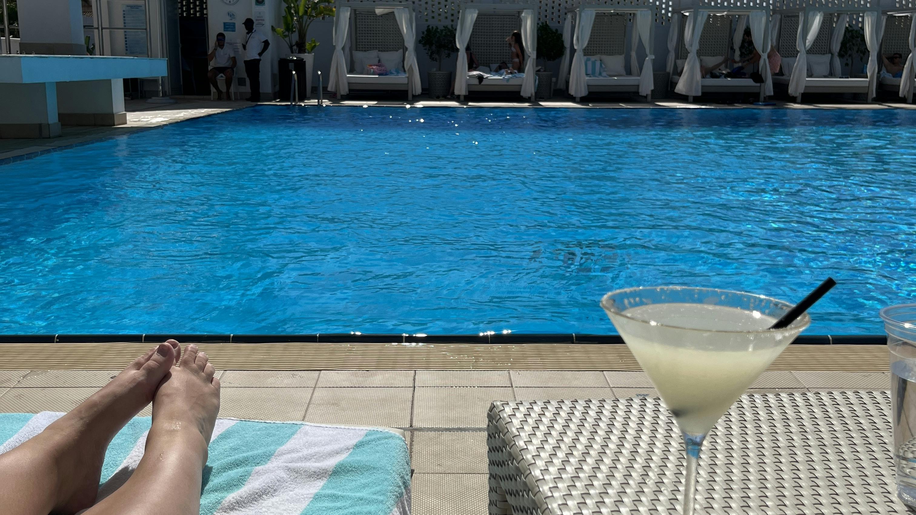 My POV: Laying by the pool in the sunshine with a cocktail next to me