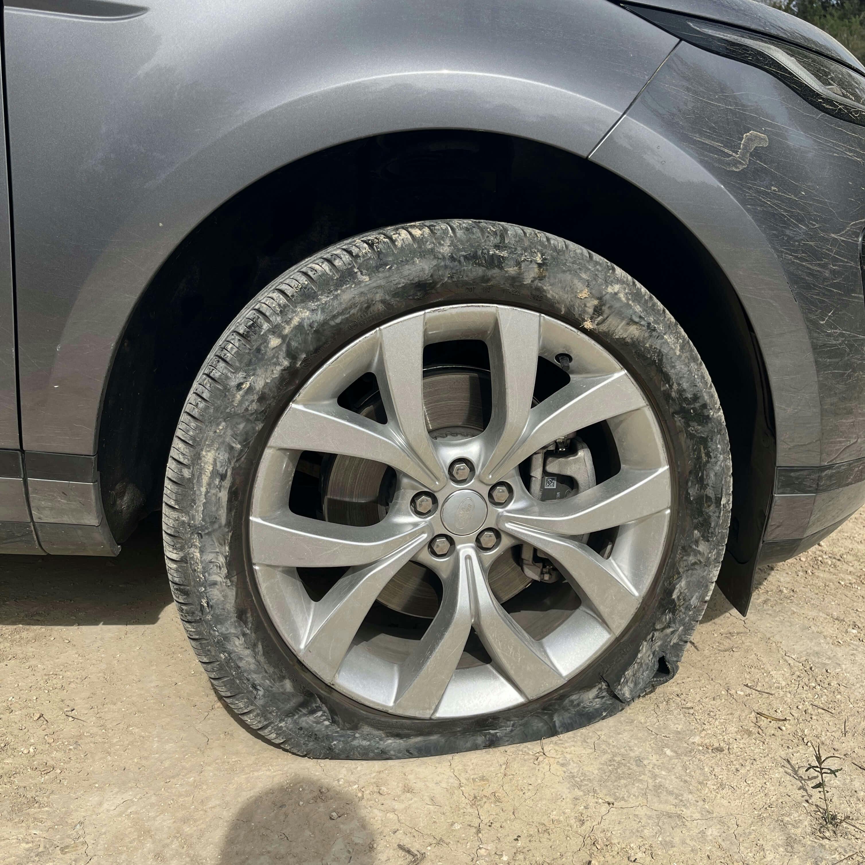 The flat tire on my rental-Range Rover, with a giant tear in it.