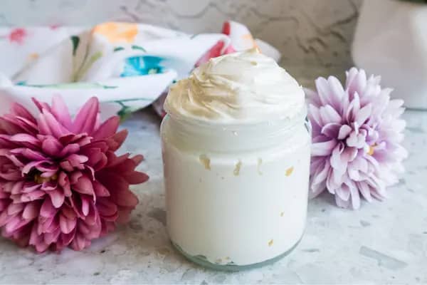 a jar of homemade whipped tallow sunscreen with zinc
