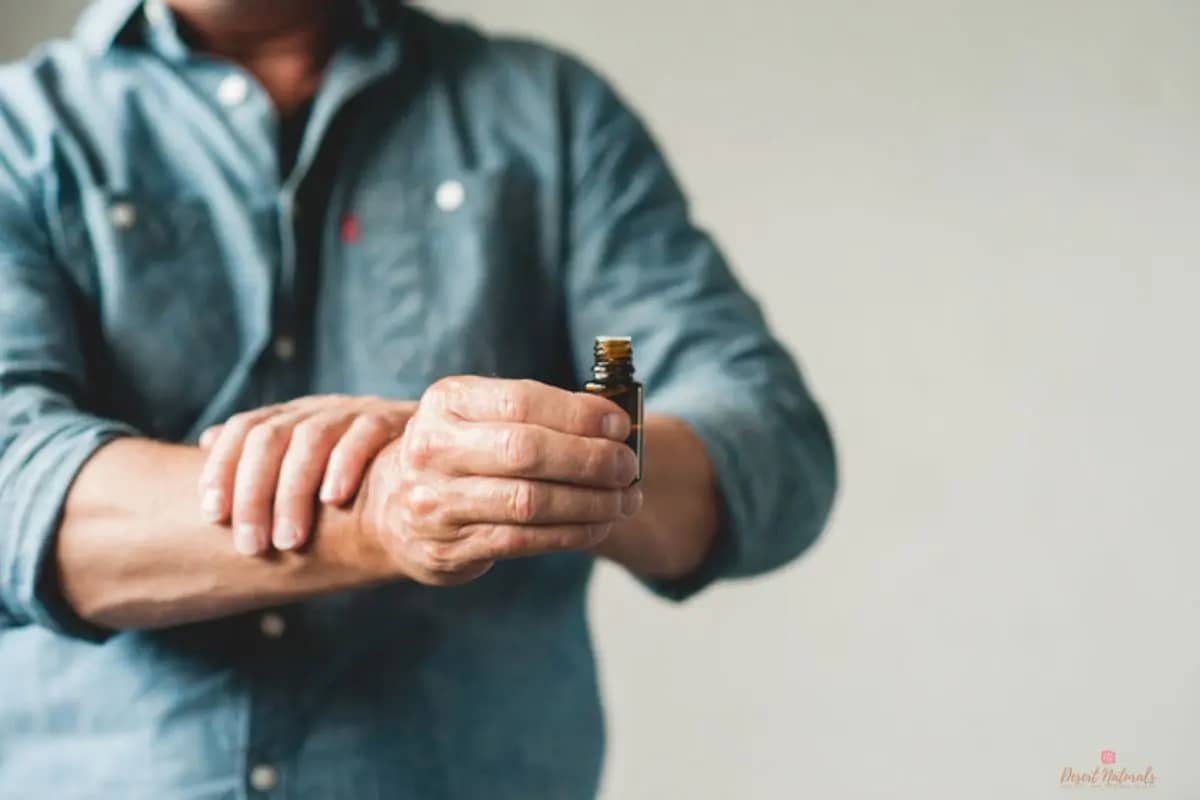 a man applying diy essential oil cologne