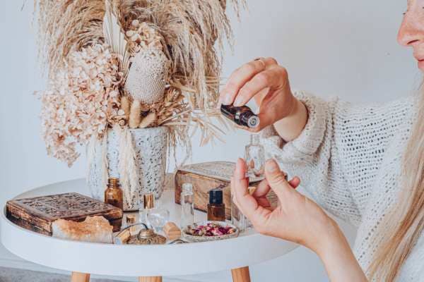 a woman making essential oil perfume in a boho style