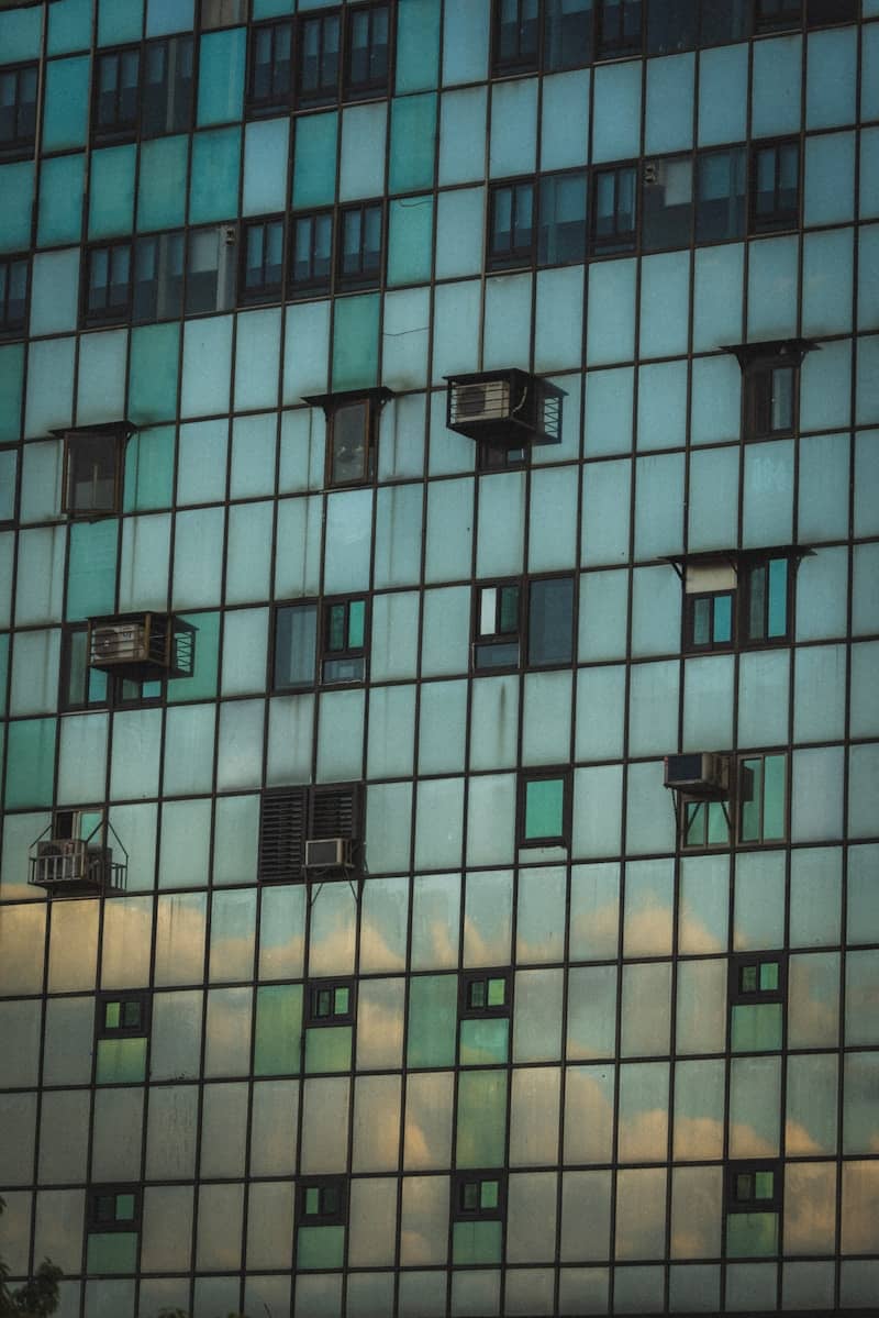 Modern building facade with many windows and air conditioners.