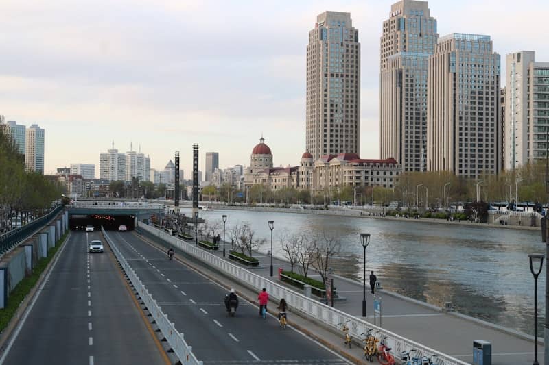 Cityscape with river, road, and modern buildings