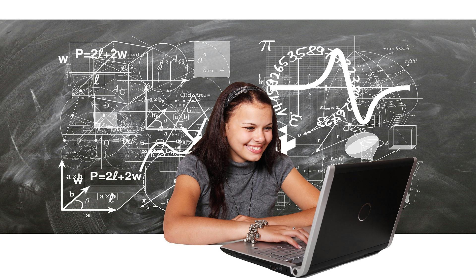 A woman on a laptop playing with many concepts and figures