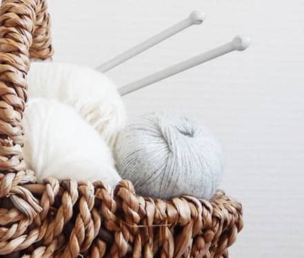 Yarn and knitting needles in a basket