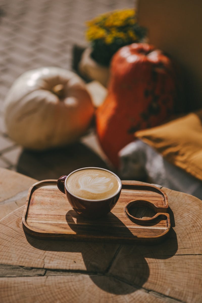 A cup of coffee sitting on top of a wooden tray