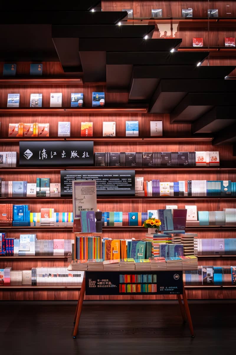 Modern bookstore interior featuring extensive bookshelves and a central display.