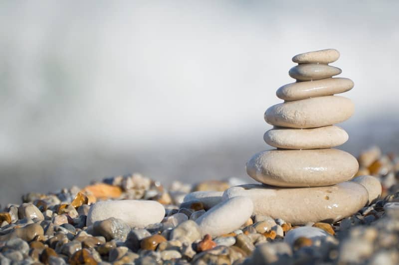 Stack of smooth stones on a pebble beach