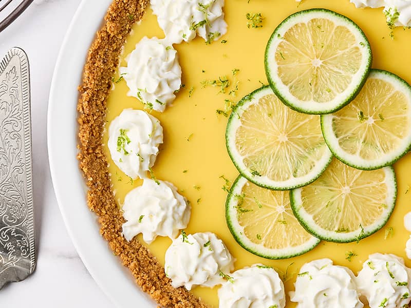 Close-up of Florida Key lime pie with graham cracker crust, whipped cream, and lime slices on top