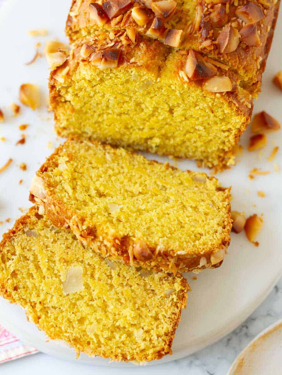 Sliced mango bread on a white surface.