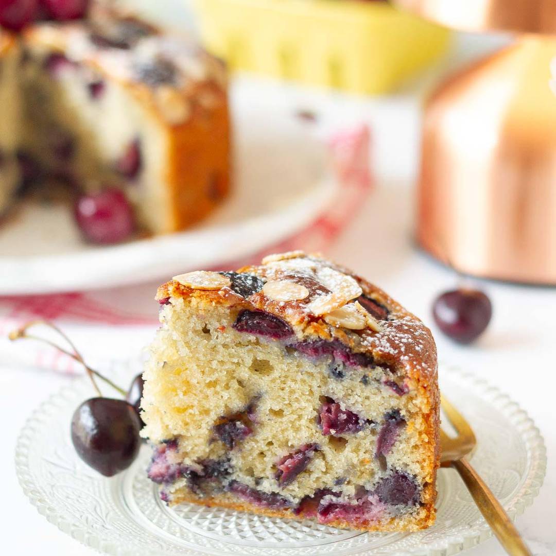A slice of cherry cake on a small plate.