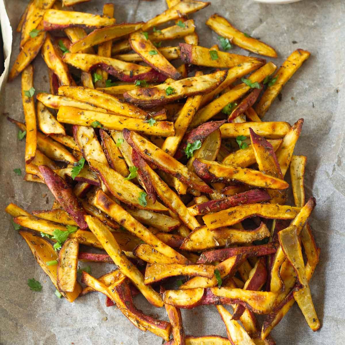 Baked sweet potatoes on parchment paper.