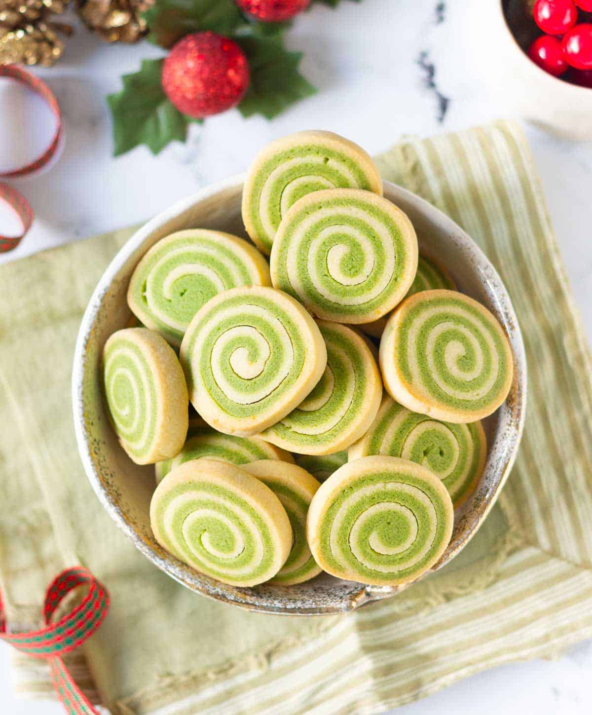 Matcha pinwheel cookies in a bowl.