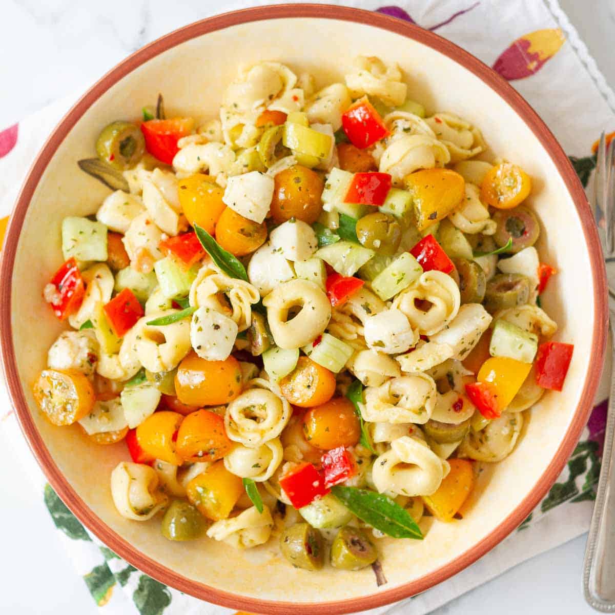 Tortellini salad with veggies in a bowl.